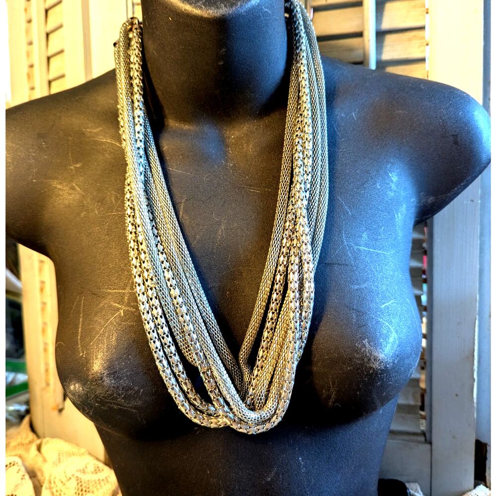 Disco style multistrand silver toned mesh bib necklace
